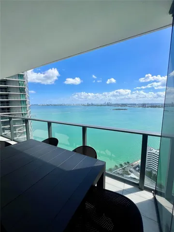 a view of a balcony with furniture