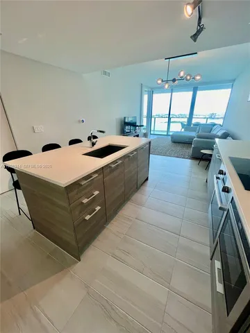 a kitchen with a sink and a stove top oven