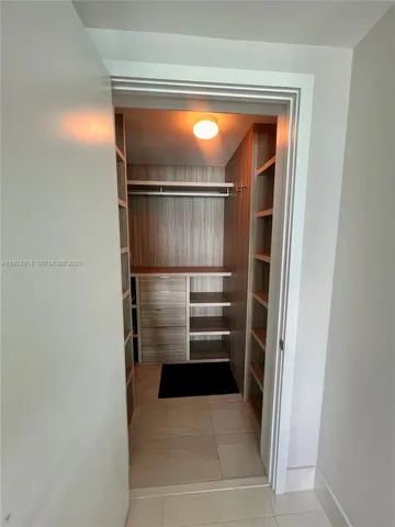 a bedroom with a bed and a lamp on table