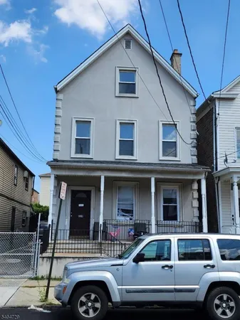 a front view of a house with parking space