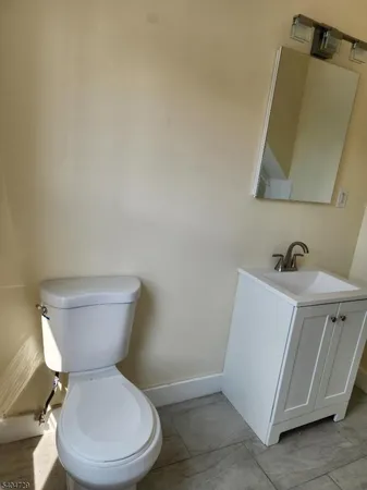 a white toilet sitting next to a bathroom sink