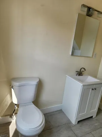 a white toilet sitting next to a bathroom sink