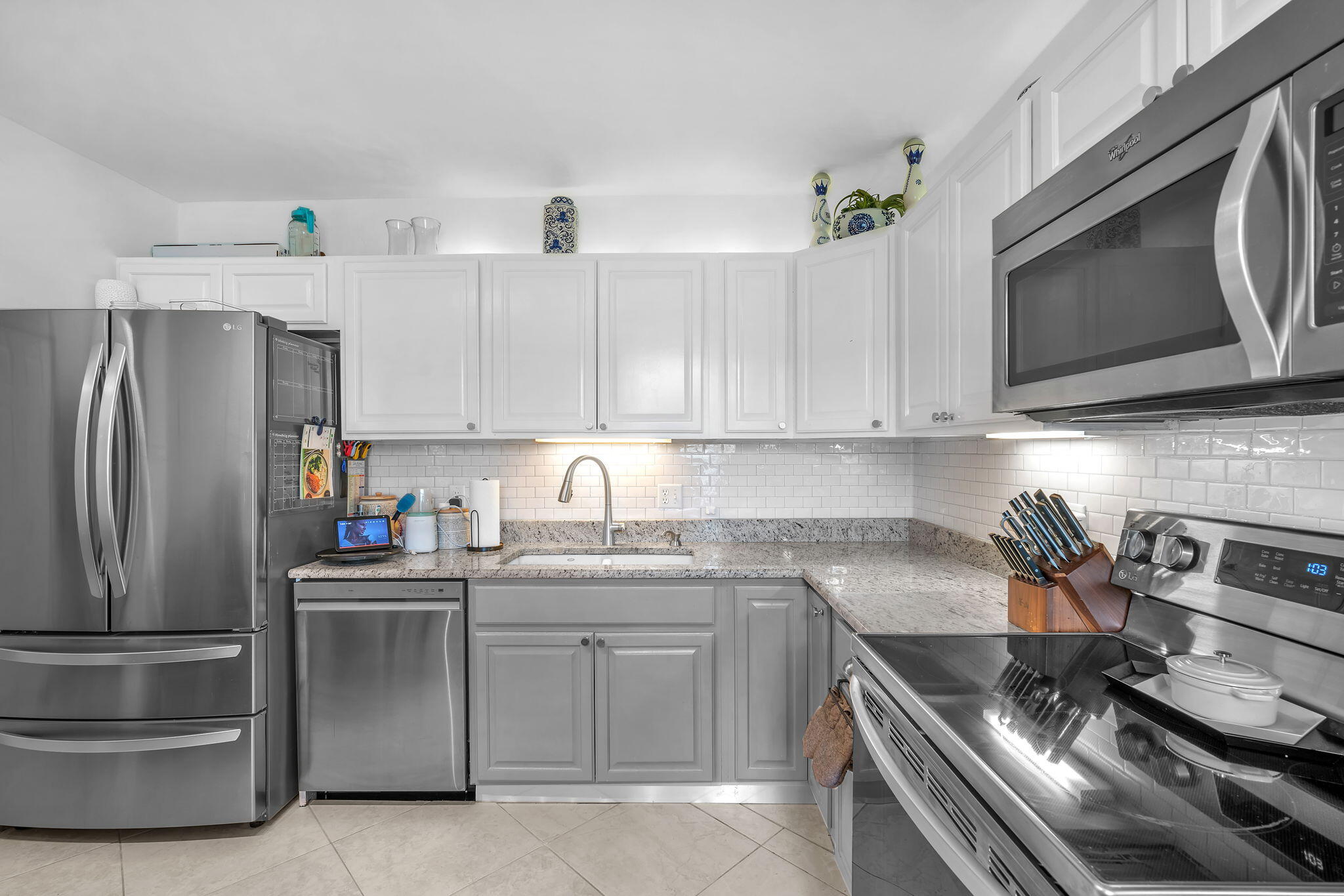 5157 Floria Way, Unit T Boynton Beach, FL 33437 - Photo 1 of 40 a kitchen with stainless steel appliances a stove a sink and cabinets