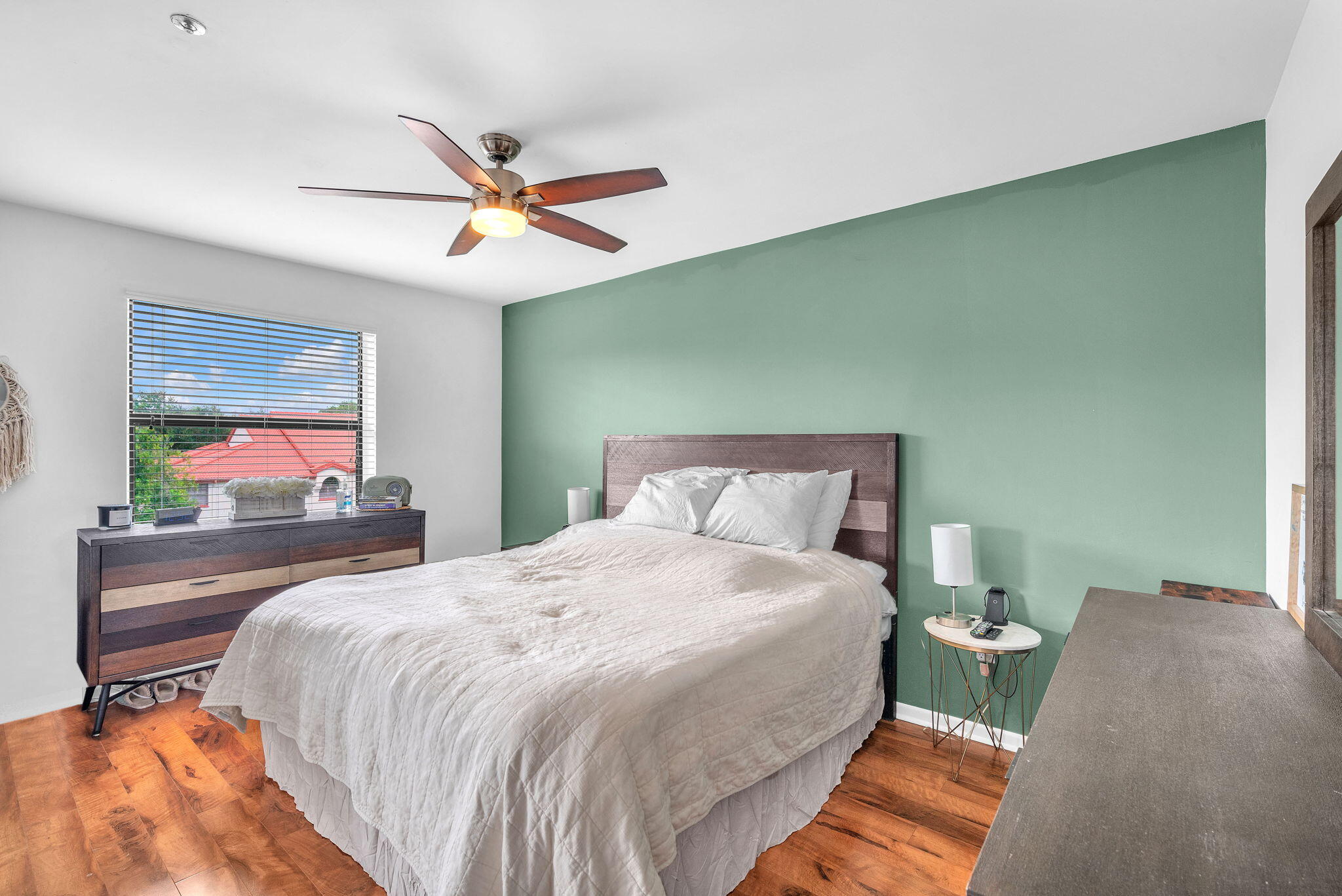 5157 Floria Way, Unit T Boynton Beach, FL 33437 - Photo 11 of 40 a bedroom with a bed and a chandelier