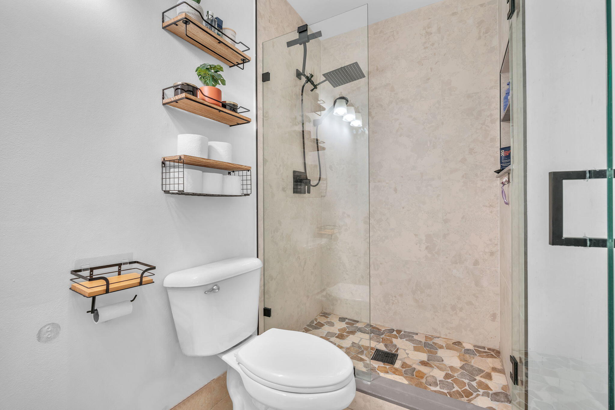 5157 Floria Way, Unit T Boynton Beach, FL 33437 - Photo 15 of 40 a white toilet sitting next to a bathroom sink and a shower