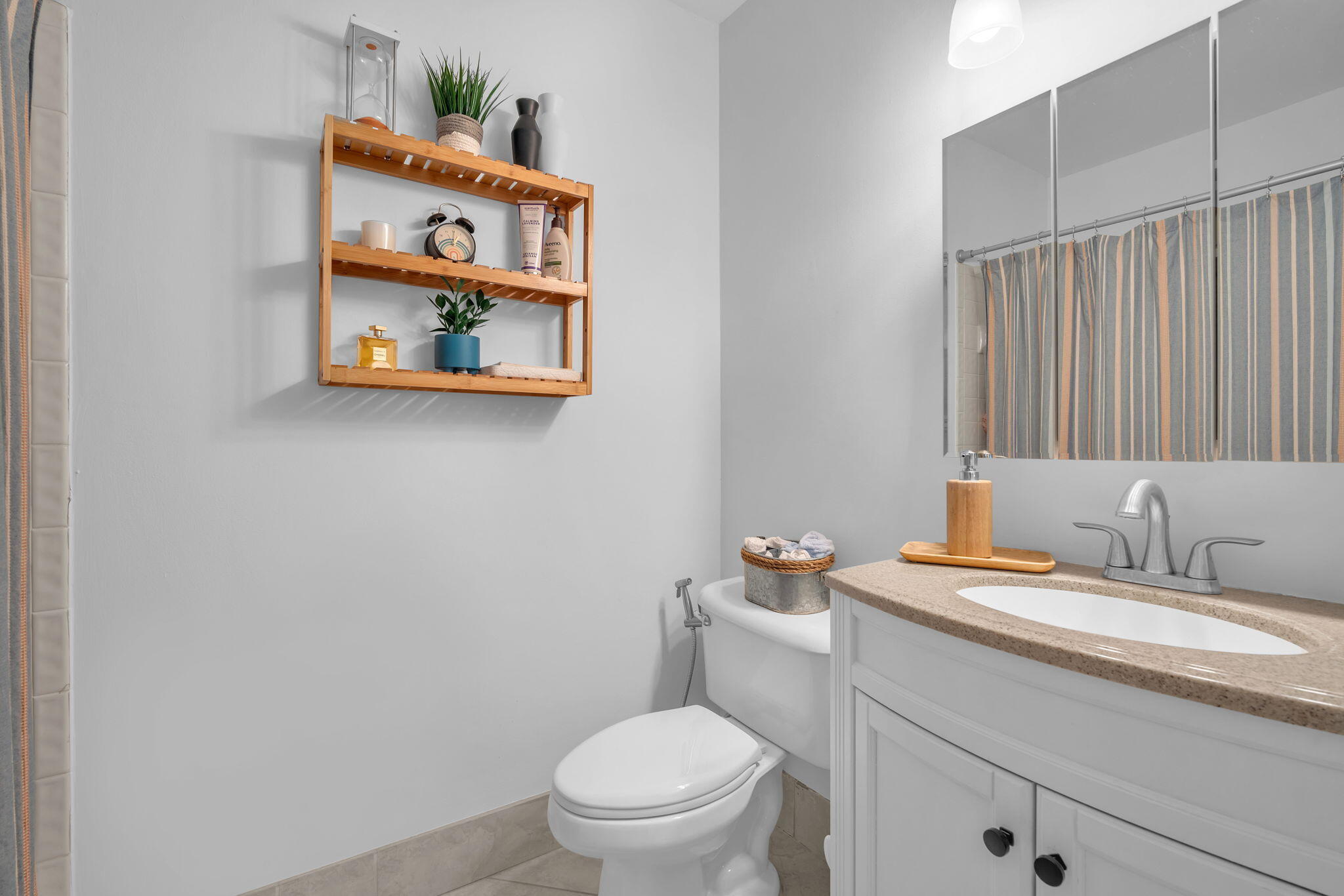 5157 Floria Way, Unit T Boynton Beach, FL 33437 - Photo 17 of 40 a bathroom with a toilet sink and mirror