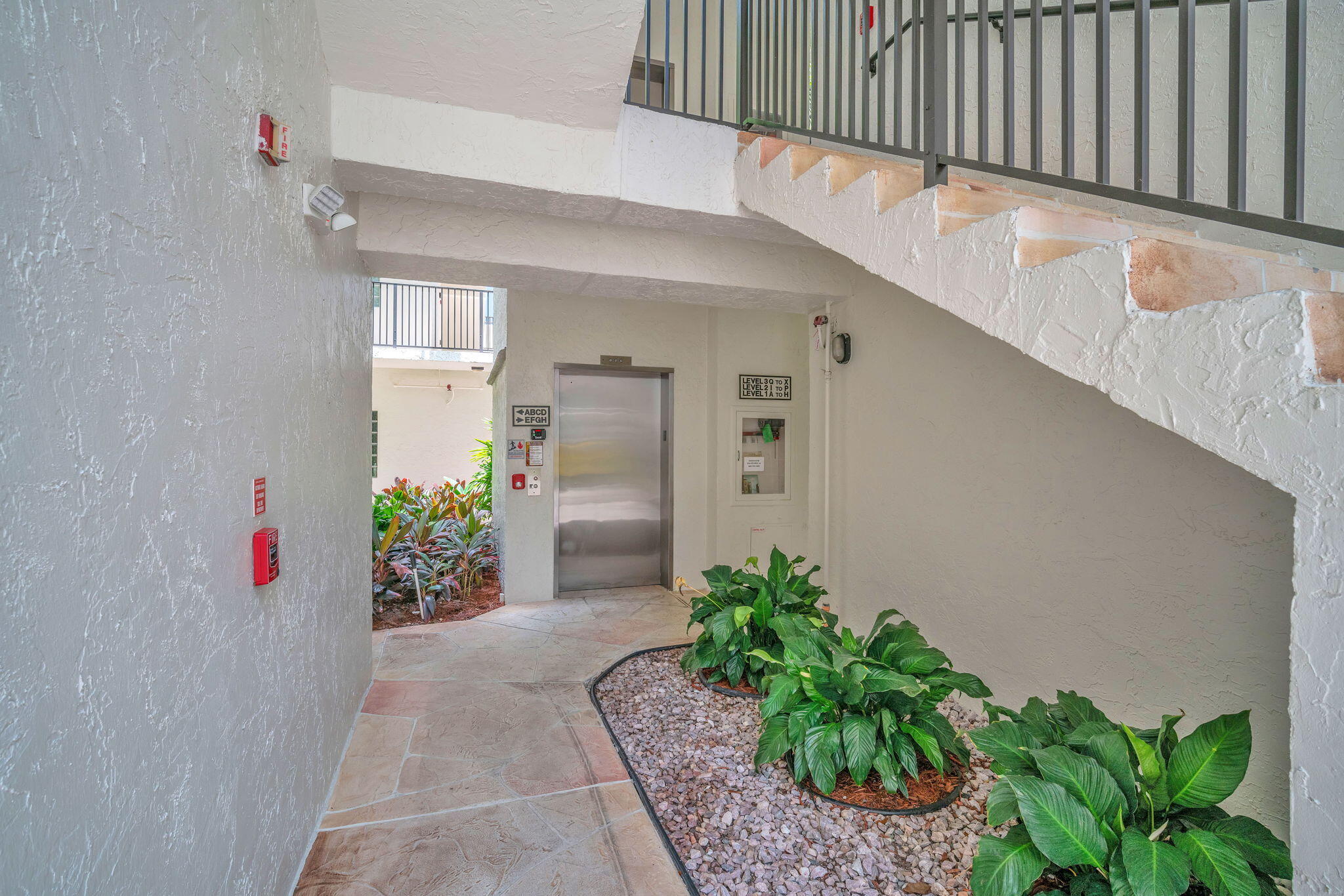 5157 Floria Way, Unit T Boynton Beach, FL 33437 - Photo 22 of 40 a entryway with flower pots