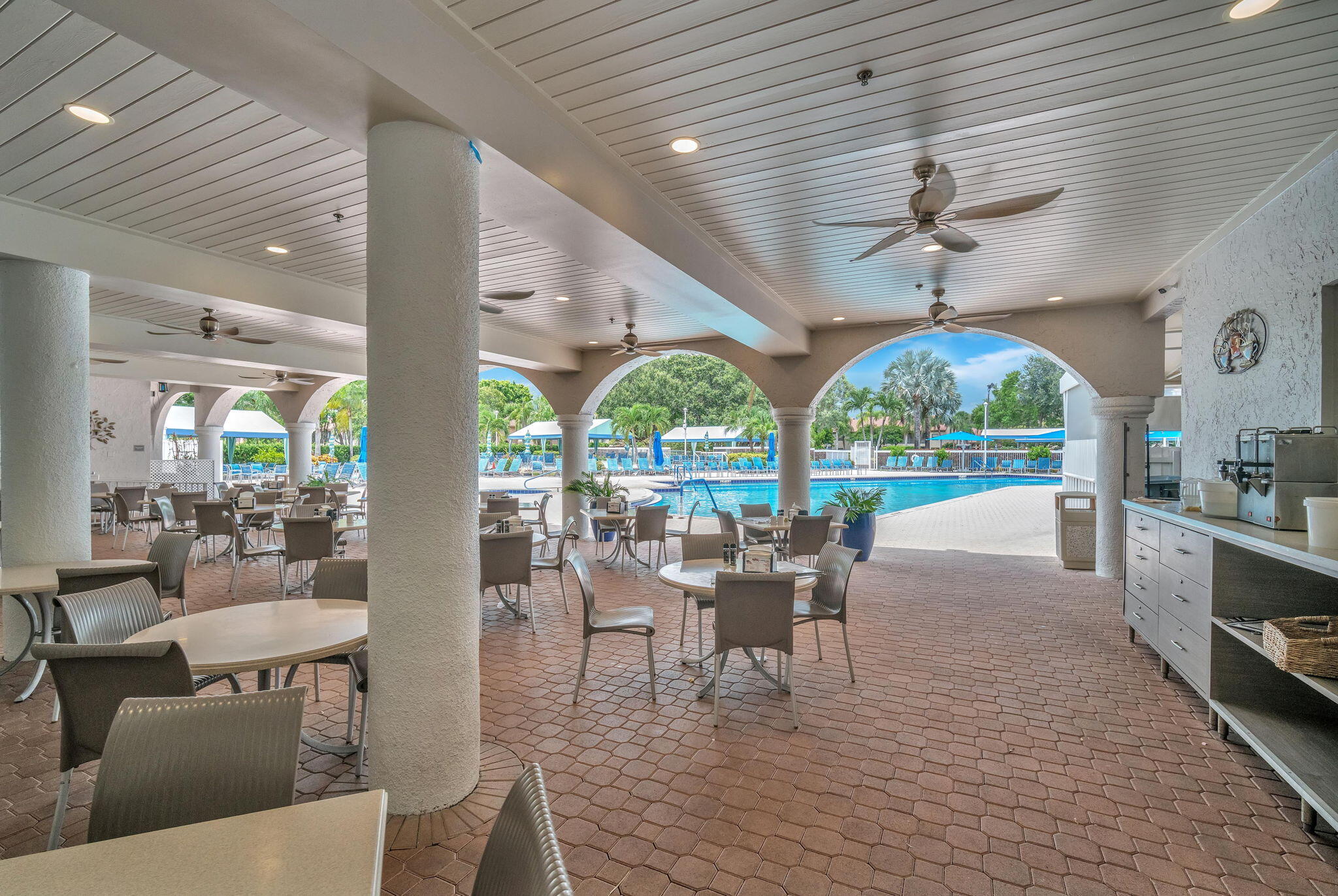 5157 Floria Way, Unit T Boynton Beach, FL 33437 - Photo 25 of 40 a view of a dining room with furniture wooden floor and chandelier