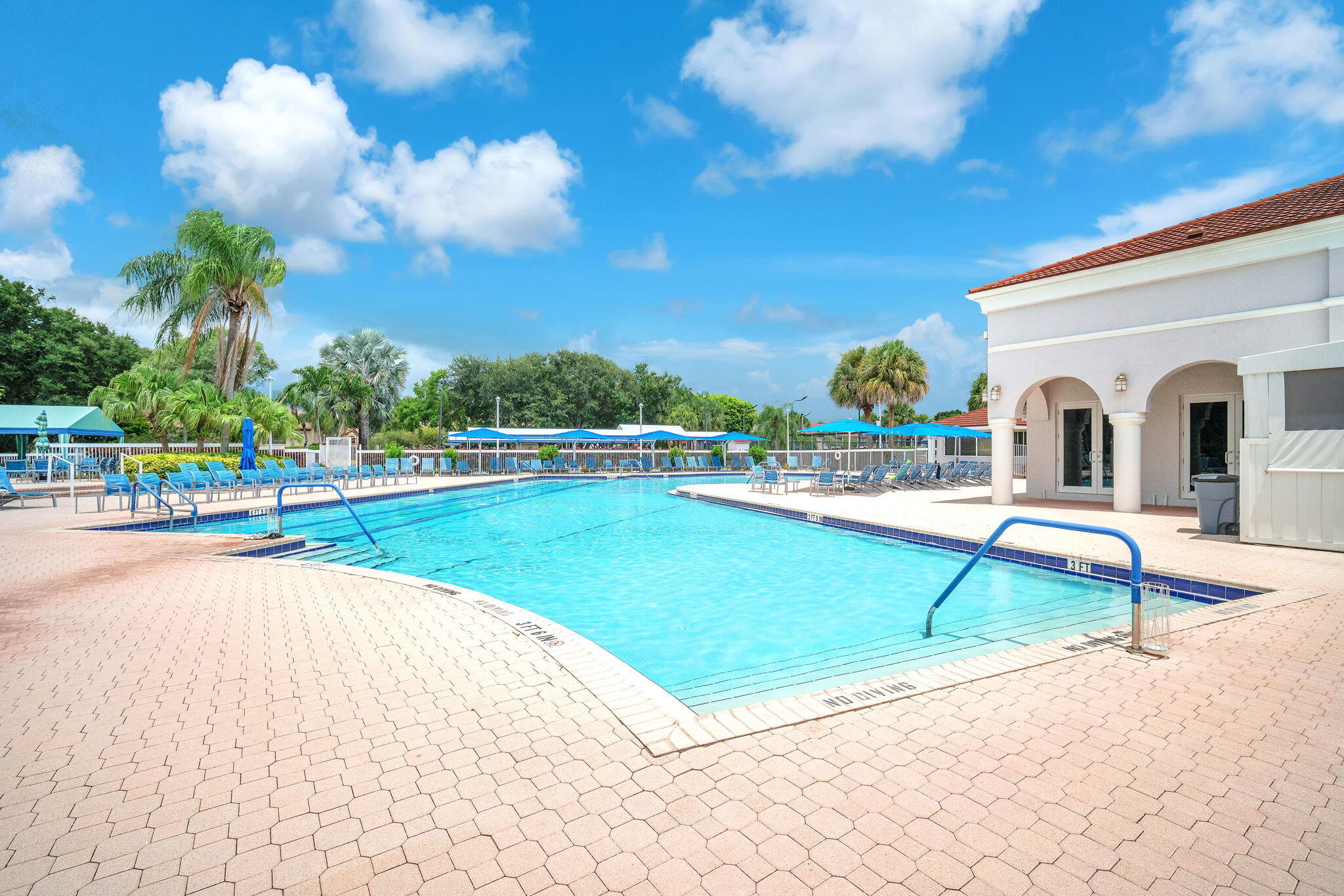 5157 Floria Way, Unit T Boynton Beach, FL 33437 - Photo 26 of 40 a view of a swimming pool with a lounge chairs