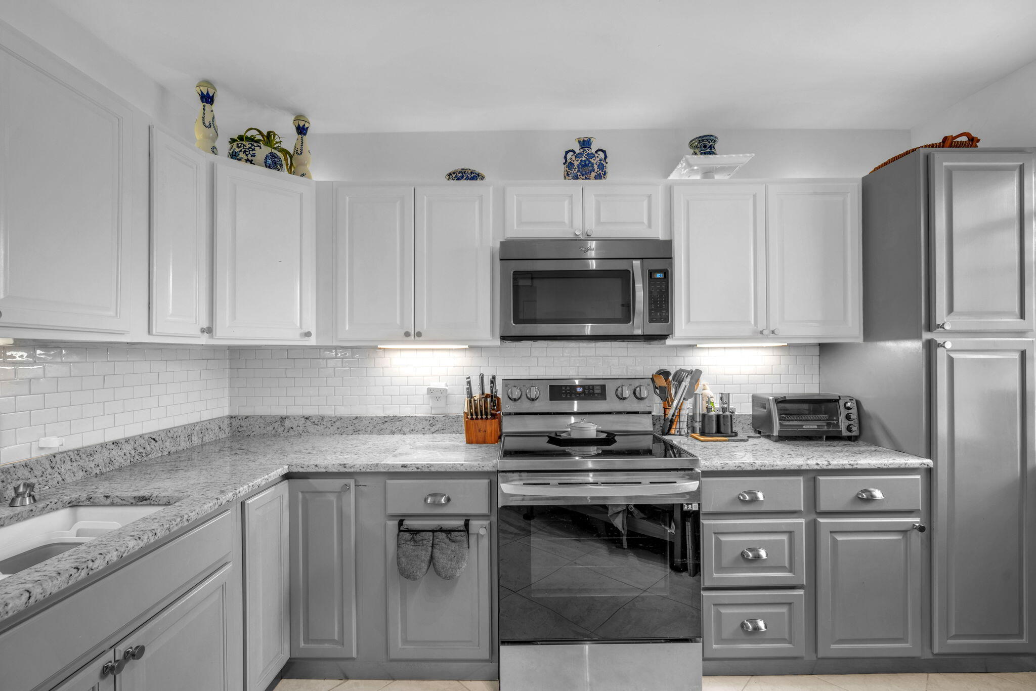 5157 Floria Way, Unit T Boynton Beach, FL 33437 - Photo 3 of 40 a kitchen with stainless steel appliances granite countertop a stove a sink dishwasher and a microwave oven on the kitchen countertops