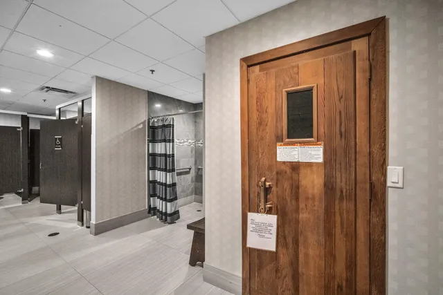 a view of a hallway with wooden shelves