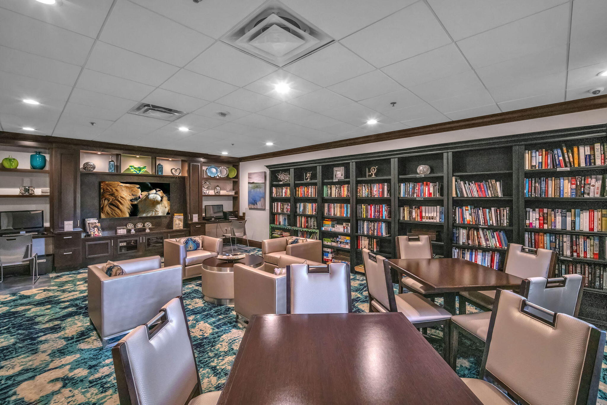 5157 Floria Way, Unit T Boynton Beach, FL 33437 - Photo 34 of 40 a living room with lots of furniture and a book shelf