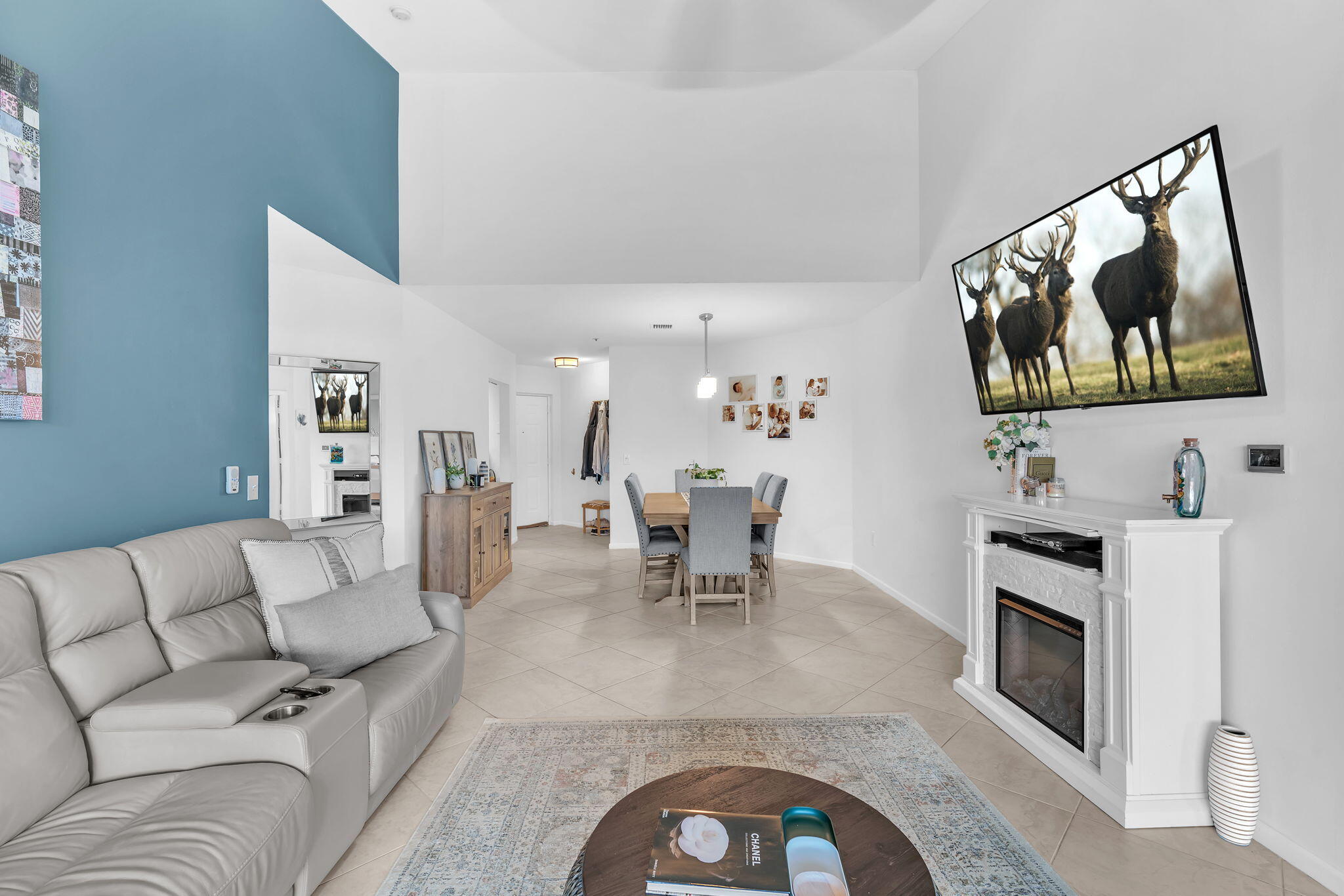 5157 Floria Way, Unit T Boynton Beach, FL 33437 - Photo 4 of 40 a living room with furniture a fireplace and a flat screen tv