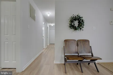 a kitchen with refrigerator a table and chairs