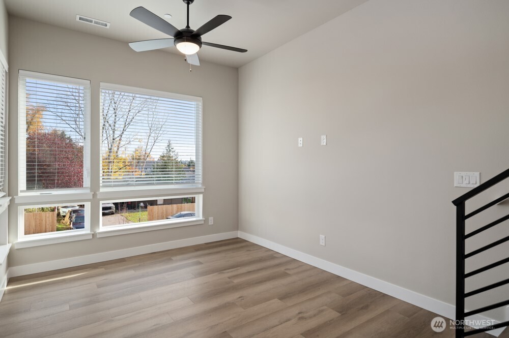 6619 South 128th Street Seattle, WA 98178 - Photo 11 of 20 a view of an empty room with a window and wooden floor