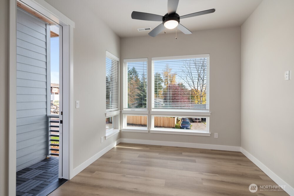 6619 South 128th Street Seattle, WA 98178 - Photo 12 of 20 a view of an empty room with a window and wooden floor