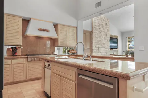 a kitchen with granite countertop a refrigerator and a stove