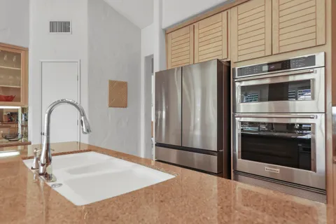 a view of a dining room with furniture large windows and wooden floor