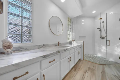 a bathroom with a sink vanity and a mirror