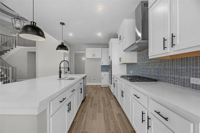 a large kitchen with stainless steel appliances lots of counter space sink and cabinets