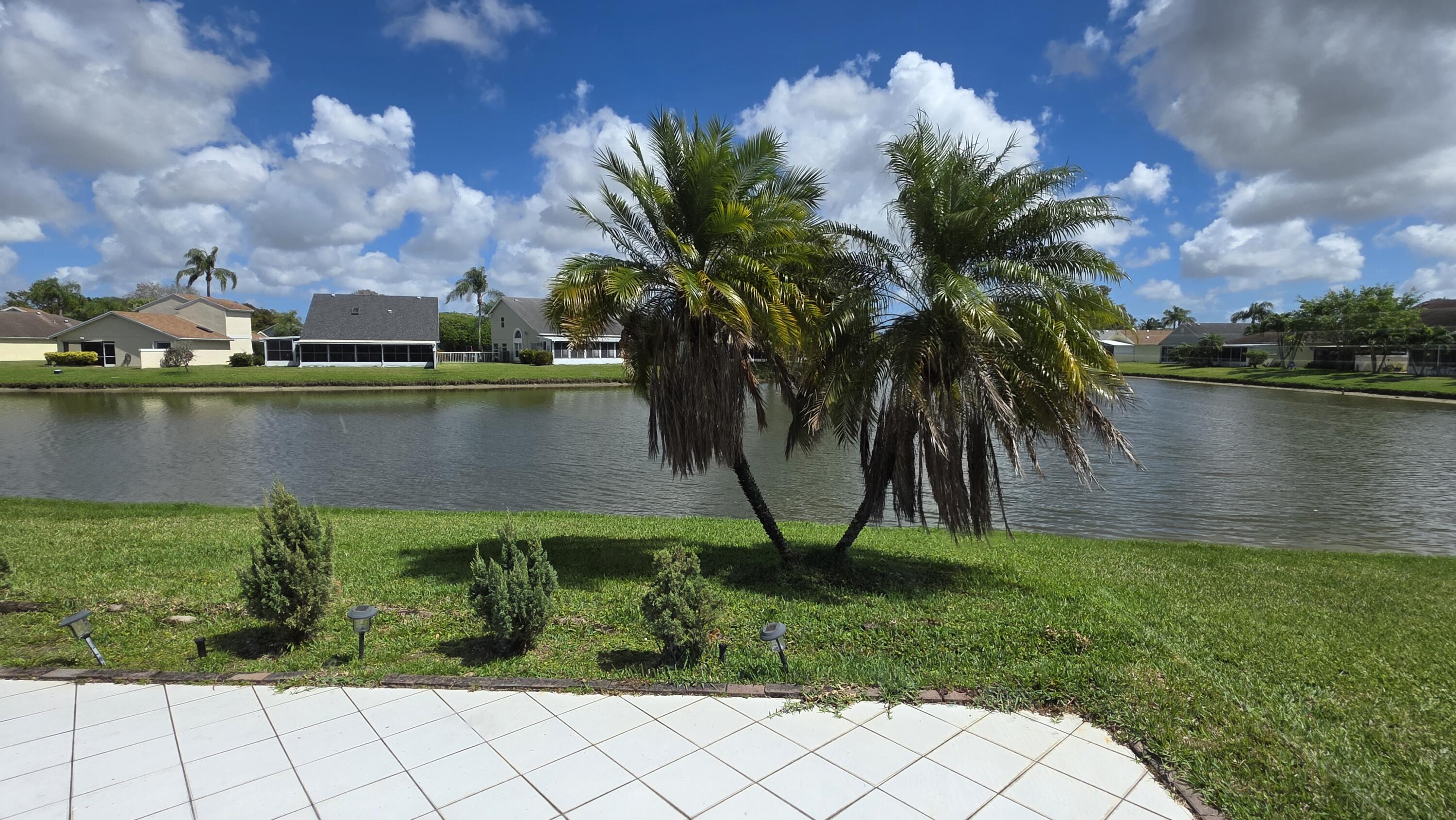 7769 Mansfield Hollow Road Delray Beach, FL 33446 - Photo 16 of 27 a view of a lake with a yard