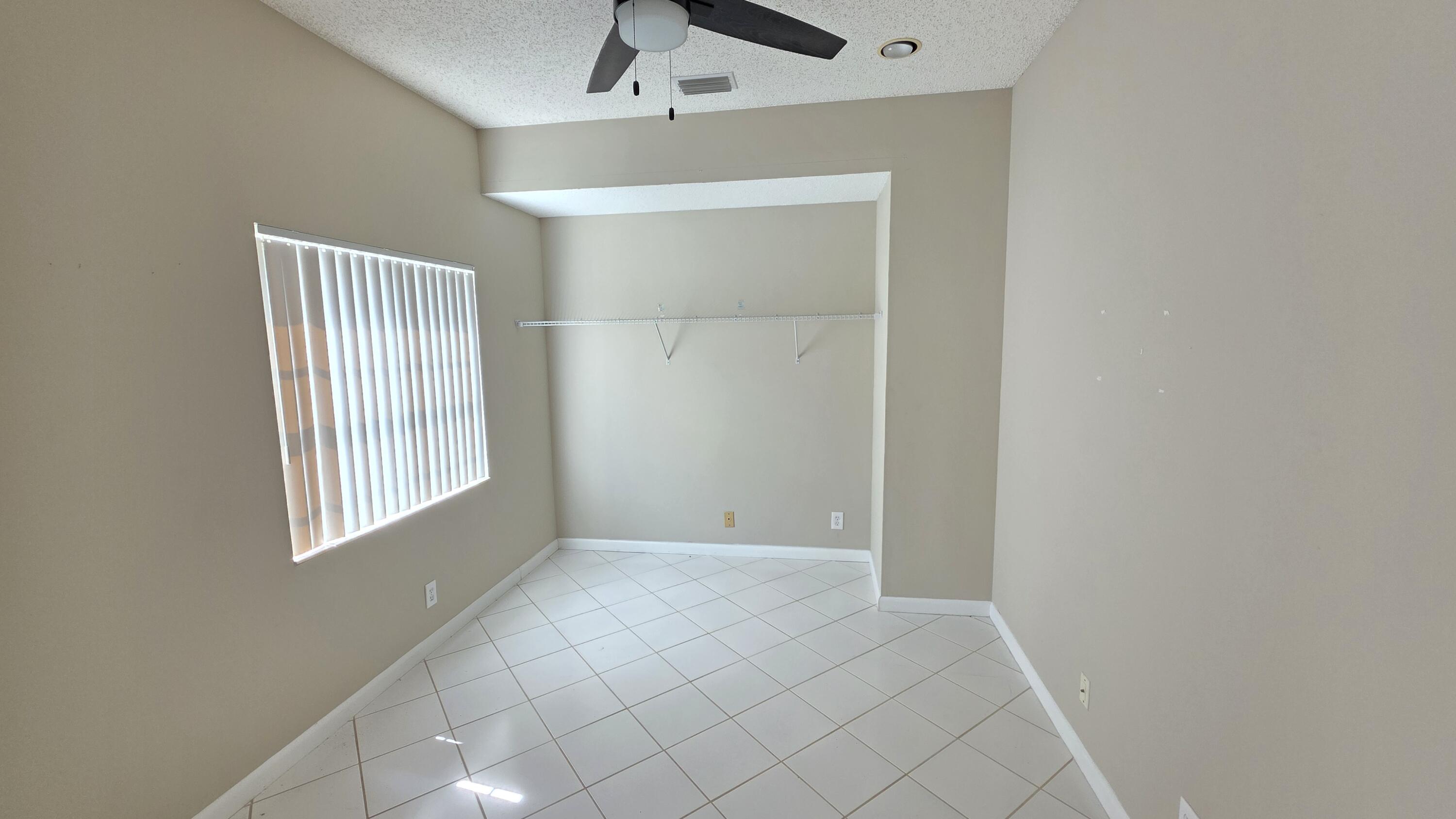 7769 Mansfield Hollow Road Delray Beach, FL 33446 - Photo 19 of 27 a view of an empty room with windows