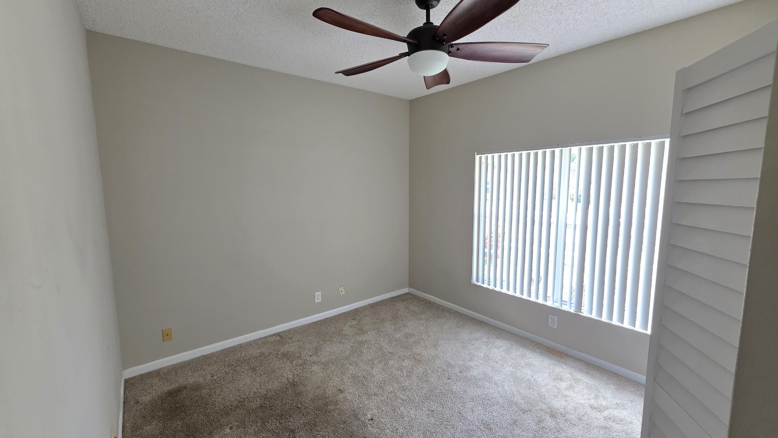 7769 Mansfield Hollow Road Delray Beach, FL 33446 - Photo 20 of 27 an empty room with a window and a ceiling fan