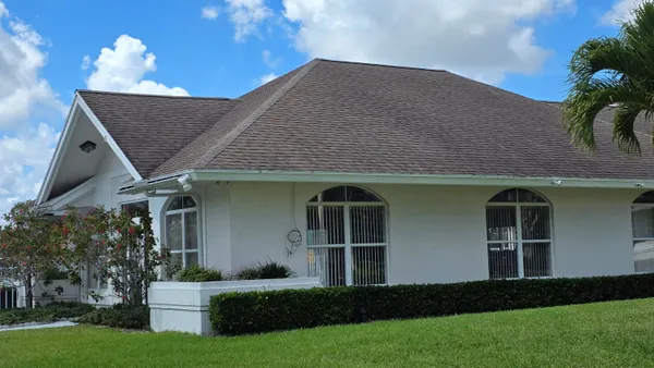 a front view of a house with garden