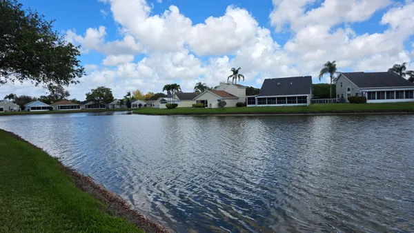 a view of a lake with houses in the back
