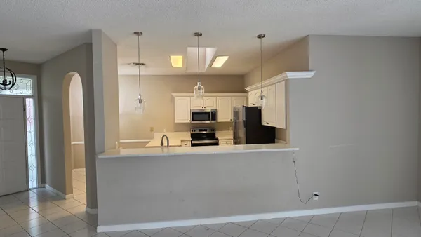 a large kitchen with a large counter top appliances and cabinets