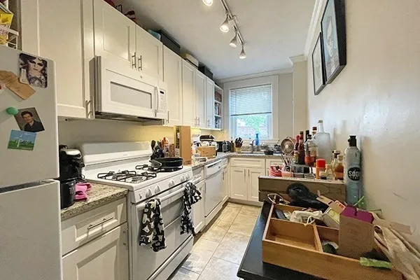 a kitchen with a sink stove and cabinets