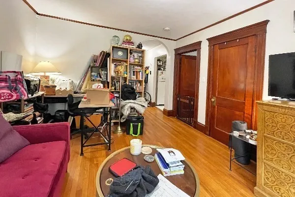 a view of a dining room with furniture a chandelier and wooden floor