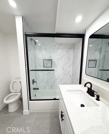a bathroom with a sink vanity and mirror