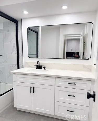 a bathroom with a double vanity sink and mirror