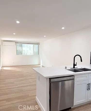 a view of a kitchen with sink and wooden floor