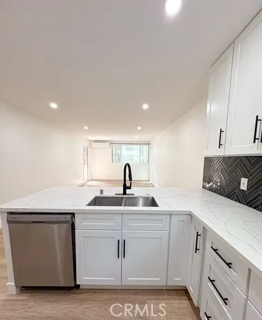 a view of kitchen with kitchen island microwave and cabinets