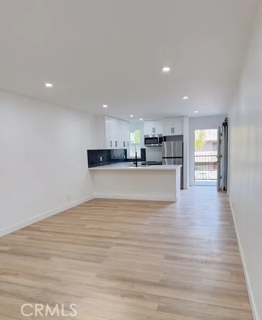 a view of kitchen and kitchen with stainless steel appliances