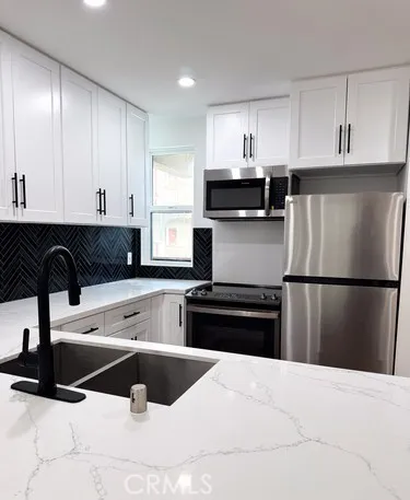 a kitchen with a refrigerator and cabinets