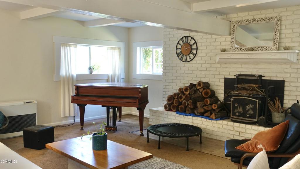31421 State Highway 20 Fort Bragg, CA 95437 - Photo 4 of 28 a living room with furniture a clock and a fireplace