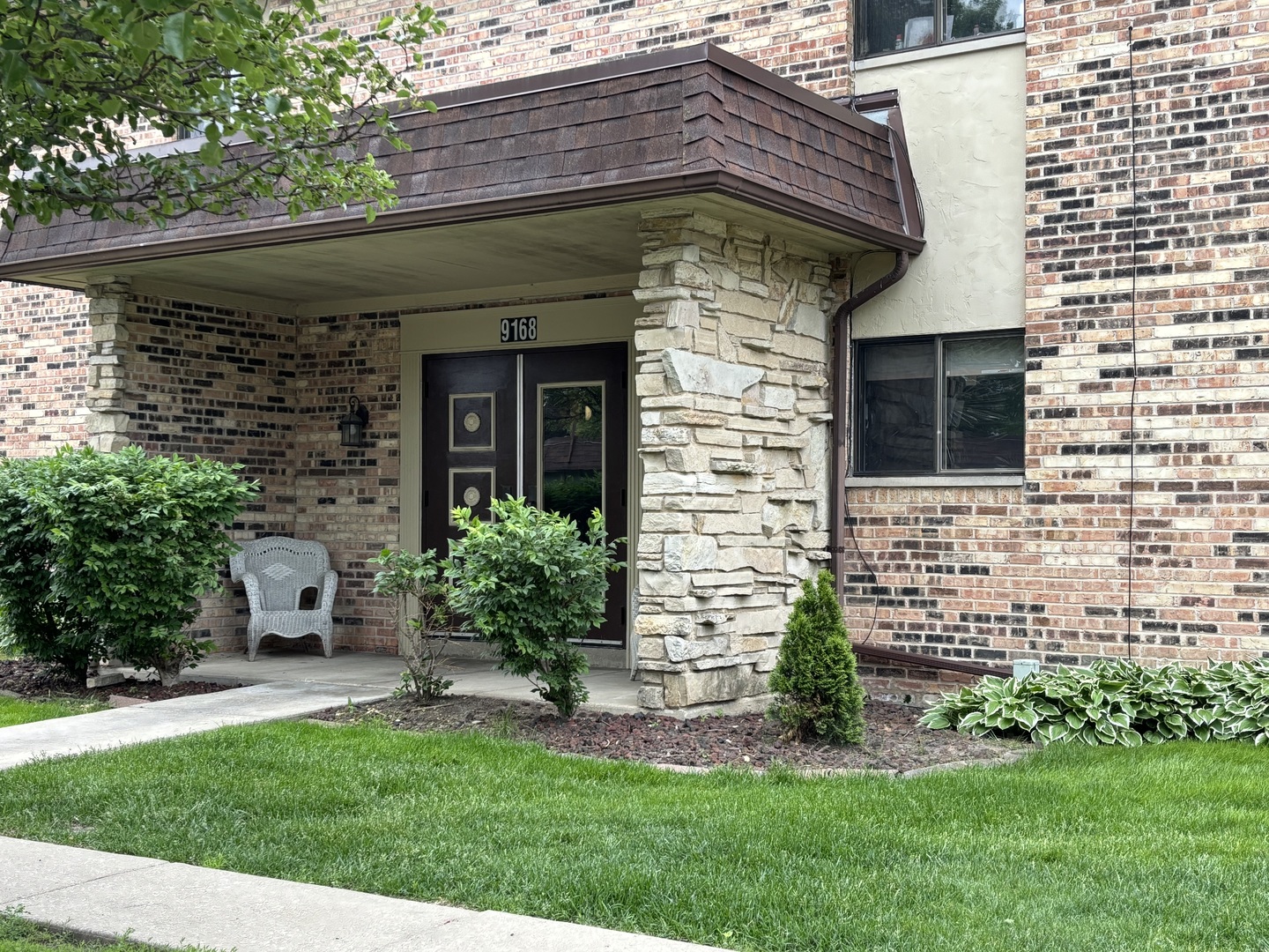 9168 S Road, Unit A Palos Hills, IL 60465 - Photo 1 of 14 a front view of a house with a yard