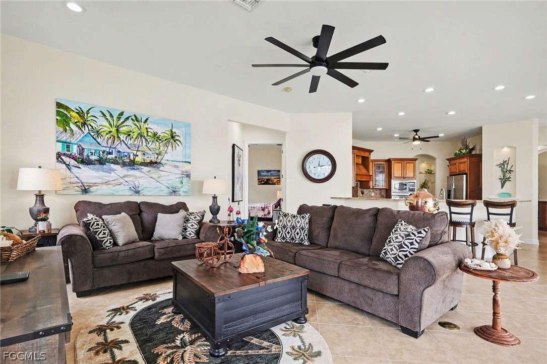 4113 Northwest 26th Street Cape Coral, FL 33993 - Photo 13 of 37 a living room with furniture and a large window