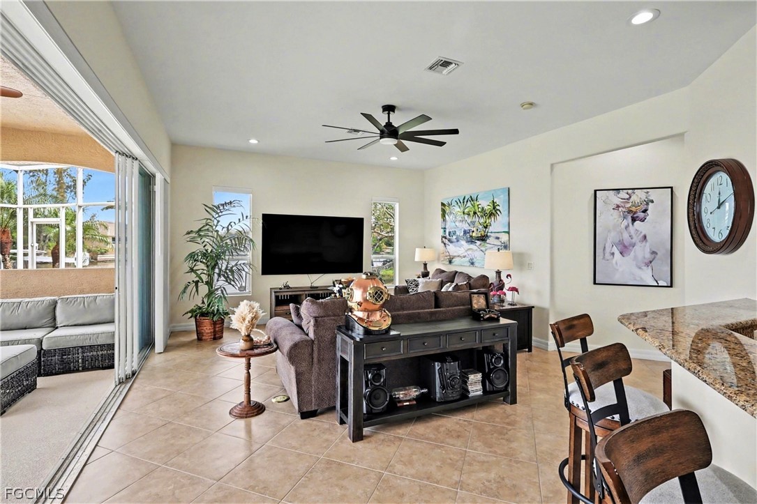 4113 Northwest 26th Street Cape Coral, FL 33993 - Photo 14 of 37 a living room with furniture and a flat screen tv
