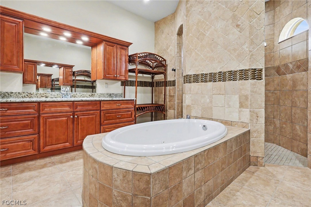 4113 Northwest 26th Street Cape Coral, FL 33993 - Photo 18 of 37 a bath tub sitting next to a bathroom sink
