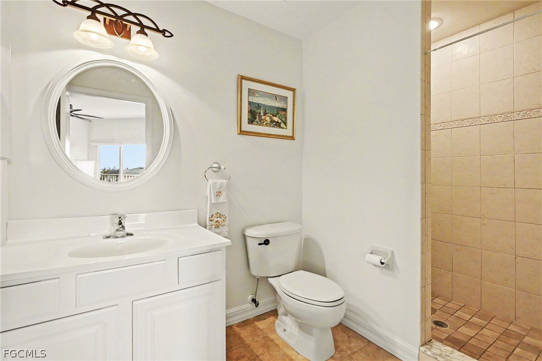 4113 Northwest 26th Street Cape Coral, FL 33993 - Photo 21 of 37 a bathroom with a toilet a sink and mirror