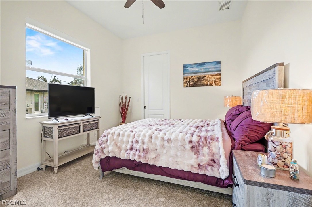 4113 Northwest 26th Street Cape Coral, FL 33993 - Photo 22 of 37 a bedroom with a bed and flat screen tv