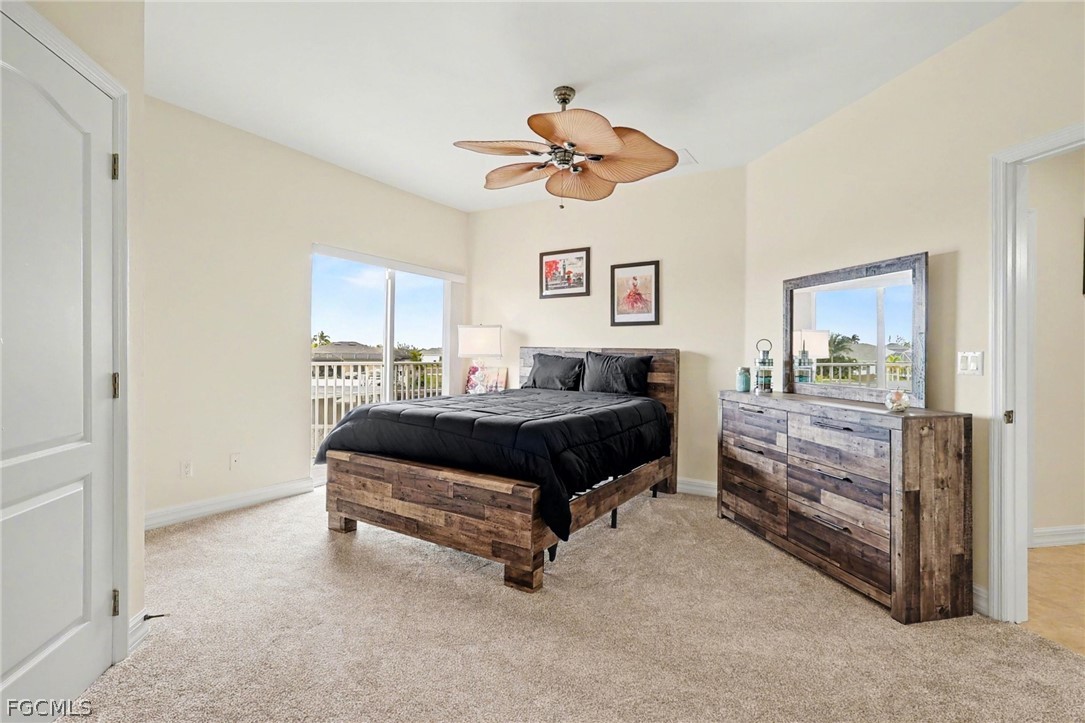 4113 Northwest 26th Street Cape Coral, FL 33993 - Photo 23 of 37 a bedroom with a bed and a chandelier