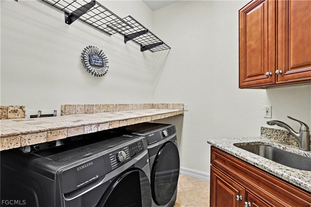 4113 Northwest 26th Street Cape Coral, FL 33993 - Photo 25 of 37 a utility room with a sink a washer and dryer