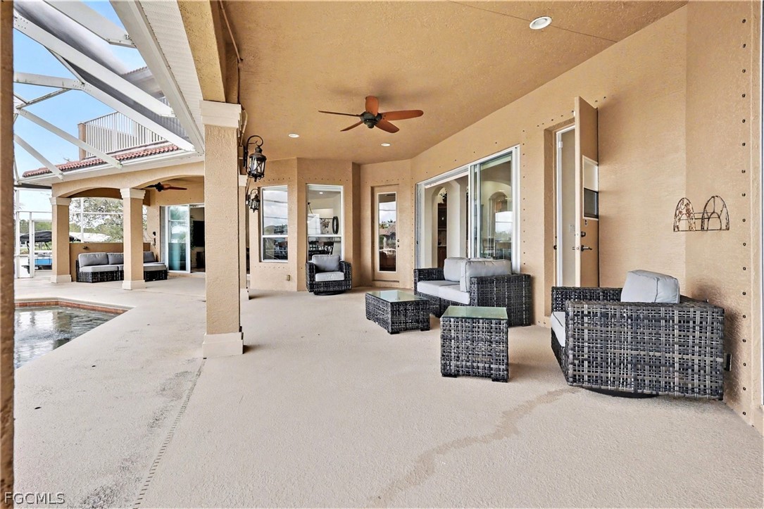 4113 Northwest 26th Street Cape Coral, FL 33993 - Photo 27 of 37 a living room with furniture and a chandelier