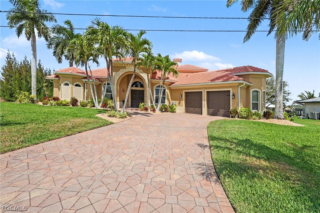 4113 Northwest 26th Street Cape Coral, FL 33993 - Photo 3 of 37 a front view of a house with a garden