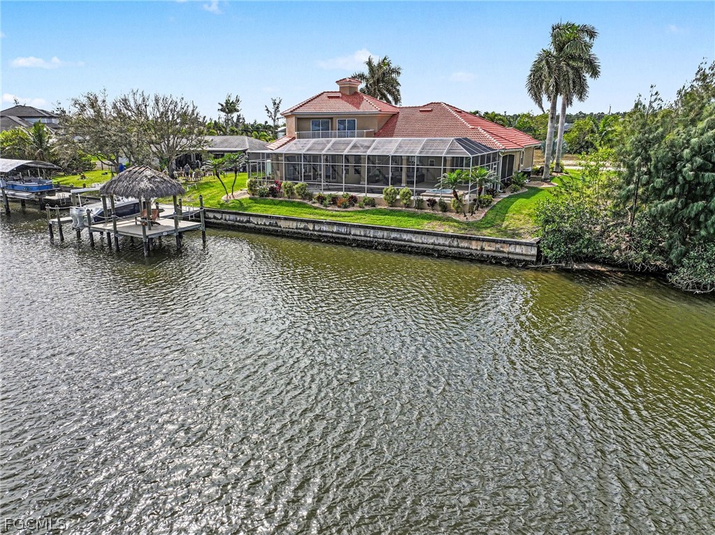 4113 Northwest 26th Street Cape Coral, FL 33993 - Photo 34 of 37 a view of a lake with a house swimming pool and outdoor seating